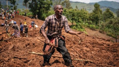 TOPSHOT - A man reacts as residents and volunteers dig in the mud in search for bodies at the scene ... TOPSHOT - A man reacts as residents and volunteers dig in the mud in search for bodies at the scene ...