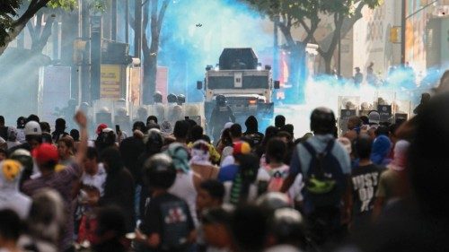 TOPSHOT - Demonstrators clash with police close to an armoured police car during a protest against ... TOPSHOT - Demonstrators clash with police close to an armoured police car during a protest against ...