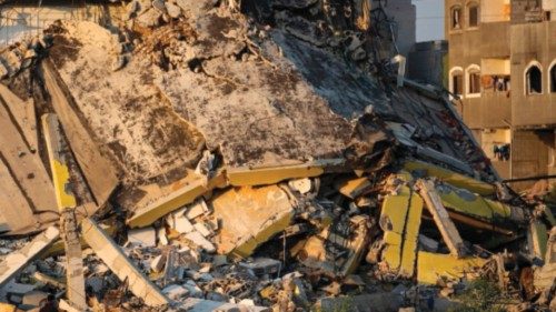 A man walks past the rubble of buildings destroyed during Israeli bombardment, near the al-Maghazi ... A man walks past the rubble of buildings destroyed during Israeli bombardment, near the al-Maghazi ...