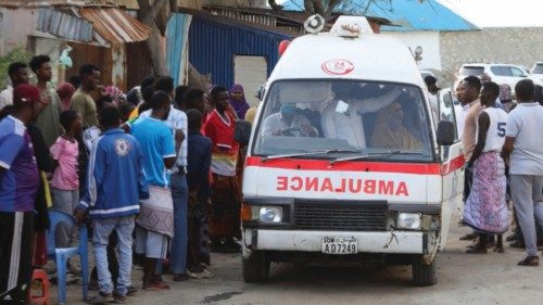 People gather as an ambulance carries the dead body of an unidentified woman killed in an explosion ... People gather as an ambulance carries the dead body of an unidentified woman killed in an explosion ...