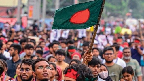 A student carrying Bangladesh national flag takes part in a protest march as protesters demand ... A student carrying Bangladesh national flag takes part in a protest march as protesters demand ...