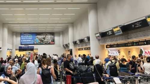 People wait in line with their luggage in the Beirut-Rafic Al Hariri International Airport, in ... People wait in line with their luggage in the Beirut-Rafic Al Hariri International Airport, in ...