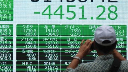 epa11526799 A pedestrian takes a photo of a display showing the closing information of the Nikkei ... epa11526799 A pedestrian takes a photo of a display showing the closing information of the Nikkei ...