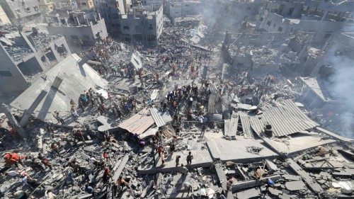 (FILES) People search for survivors and the bodies of victims through the rubble of buildings ... (FILES) People search for survivors and the bodies of victims through the rubble of buildings ...