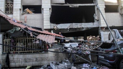 epa11541959 Palestinians inspect the damage following an Israeli strike on the Al-Taba'een school in ...