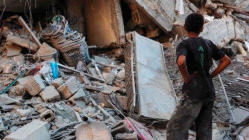 TOPSHOT - People look for salvageable items in the rubble of a building destroyed during Israeli ... TOPSHOT - People look for salvageable items in the rubble of a building destroyed during Israeli ...