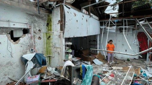 This photo taken on August 10, 2024 shows a woman looking on from a damaged building in Lashio in ... This photo taken on August 10, 2024 shows a woman looking on from a damaged building in Lashio in ...