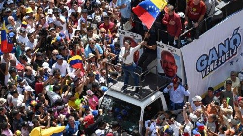 TOPSHOT - Venezuelan opposition leader Maria Corina Machado (C) waves a national flag from atop a ... TOPSHOT - Venezuelan opposition leader Maria Corina Machado (C) waves a national flag from atop a ...