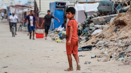 (FILES) A Palestinian child walks along street riddled with rubbish and rubble in Khan Yunis, on the ... (FILES) A Palestinian child walks along street riddled with rubbish and rubble in Khan Yunis, on the ...