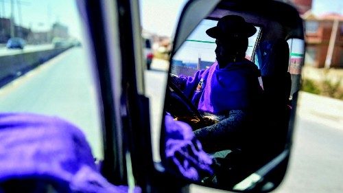 Felicidad Quispe is reflected on a mirror as she works driving a taxi, breaking gender stereotypes ...
