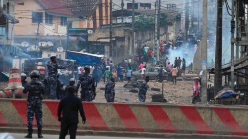 Ivorian anti-riot police use teargas to disperse crowds during the demolition of second-hand car ... Ivorian anti-riot police use teargas to disperse crowds during the demolition of second-hand car ...