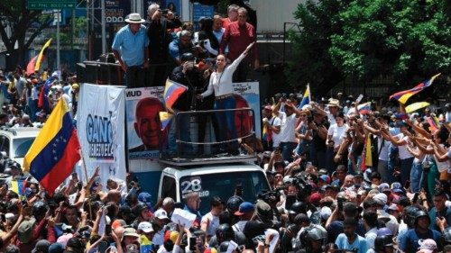 TOPSHOT - Venezuelan opposition leader Maria Corina Machado (C), waves from atop a truck during a ...
