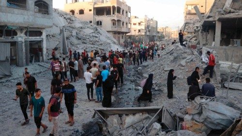 TOPSHOT - Palestinians gather to check a building shortly after it was levelled by Israeli bombing ... TOPSHOT - Palestinians gather to check a building shortly after it was levelled by Israeli bombing ...