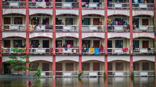TOPSHOT - Flood affected people take shelter inside a school building in Daganbhuiyan in Feni, on ...