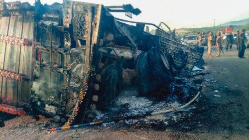 Security personnel stand guard near the charred vehicle at the shooting site on the national highway ... Security personnel stand guard near the charred vehicle at the shooting site on the national highway ...