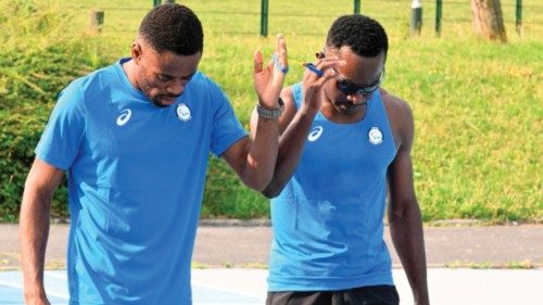 Guillaume Junior Atangana (R) a blind para-athlete, and his guide Donard Ndim Nyamjua, train for the ...