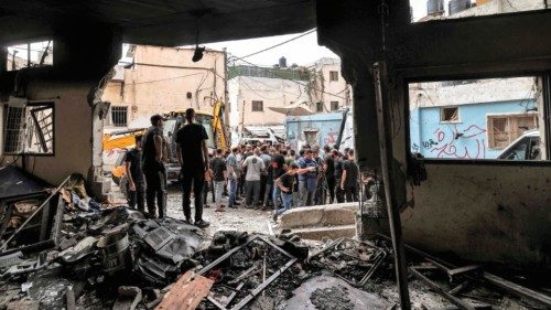 People inspect damage to a mosque building following an Israeli military operation in the Fara camp ...