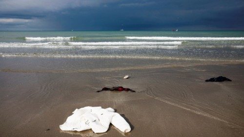 Items of clothing left by migrants are seen, after leaving their hiding place, on the beach of the ... Items of clothing left by migrants are seen, after leaving their hiding place, on the beach of the ...