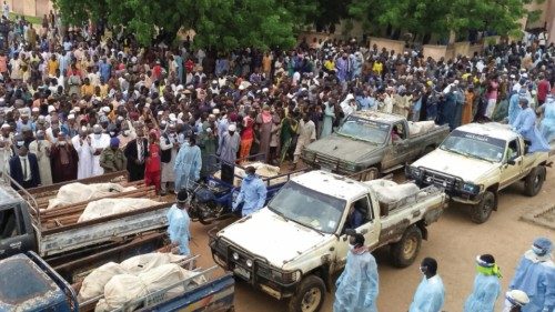 Trucks carry the wrapped bodies of people killed by suspected Boko Haram militants, during their ... Trucks carry the wrapped bodies of people killed by suspected Boko Haram militants, during their ...