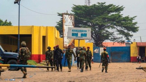 TOPSHOT - Military reinforcements walk the entrance of Makala Prison in Kinshasa on September 3, ... TOPSHOT - Military reinforcements walk the entrance of Makala Prison in Kinshasa on September 3, ...