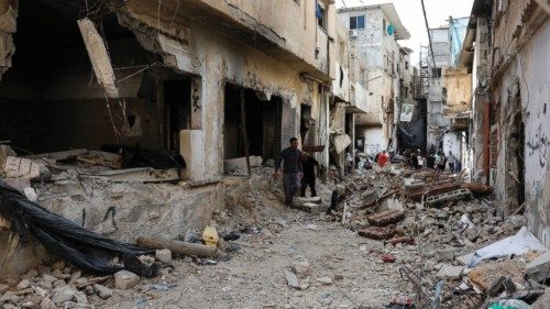 Palestinians inspect the damage to buildings, following an Israeli military raid, in Tulkarm, in the ...
