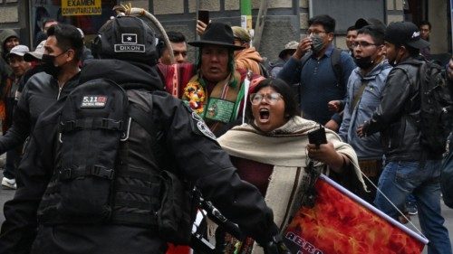 TOPSHOT - A woman shouts slogans in front of riot police officers during a protest to demand the ... TOPSHOT - A woman shouts slogans in front of riot police officers during a protest to demand the ...