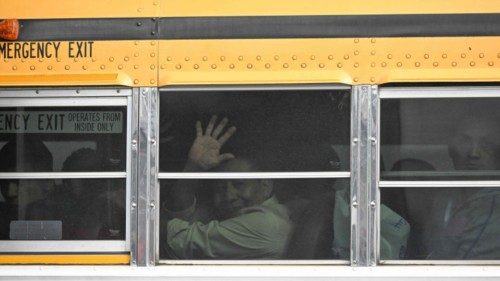TOPSHOT - A released Nicaraguan political prisoner waves aboard a bus upon arrival at the Air Force ...