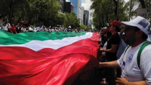 Demonstrators wave a giant Mexico flag as they march along Paseo de la Reforma Avenue during a ... Demonstrators wave a giant Mexico flag as they march along Paseo de la Reforma Avenue during a ...