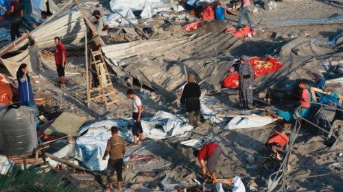TOPSHOT - Palestinians inspect the damage at the site of Israeli strikes on a makeshift displacement ... TOPSHOT - Palestinians inspect the damage at the site of Israeli strikes on a makeshift displacement ...