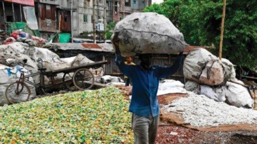 A worker carries a sack filled with plastic waste for recycling in Dhaka on September 8, 2024. ... A worker carries a sack filled with plastic waste for recycling in Dhaka on September 8, 2024. ...