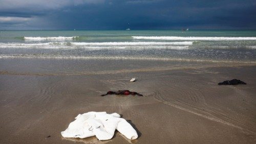 Items of clothing left by migrants are seen, after leaving their hiding place, on the beach of the ... Items of clothing left by migrants are seen, after leaving their hiding place, on the beach of the ...