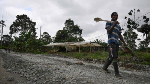 Locals leave after working on the construction of a road financed by the FARC dissident group ...