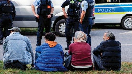(FILES) A group of migrants waits on the side of the road as they are controlled by officers of the ... (FILES) A group of migrants waits on the side of the road as they are controlled by officers of the ...