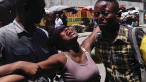 A woman is helped by others as she reacts upon seeing the dead body of her brother who was shot dead ... A woman is helped by others as she reacts upon seeing the dead body of her brother who was shot dead ...