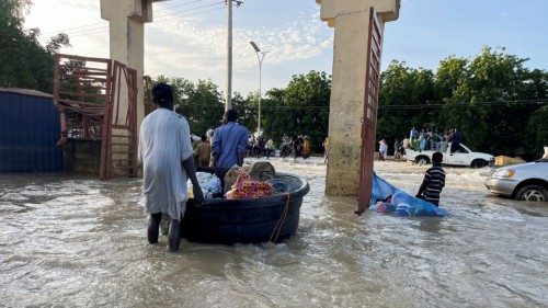 Flood victims push their belongings along a flooded road as they move to safety, in Maiduguri, ... Flood victims push their belongings along a flooded road as they move to safety, in Maiduguri, ...