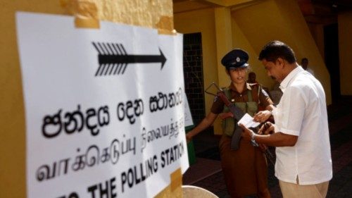 A security personnel checks documents of a voter at a polling station during the presidential ... A security personnel checks documents of a voter at a polling station during the presidential ...