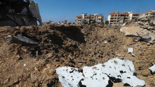 Debris lies on the ground at the site of an Israeli strike that hit the Lebanese seaside town of ... Debris lies on the ground at the site of an Israeli strike that hit the Lebanese seaside town of ...