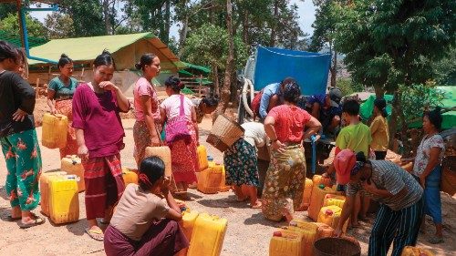 This photo taken on April 29, 2024 shows Kayah people gathering at a delivery of drinking water by ... This photo taken on April 29, 2024 shows Kayah people gathering at a delivery of drinking water by ...
