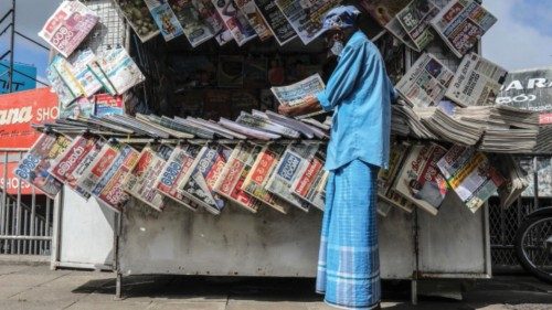 epa11623304 A man reads a newspaper at a roadside stall, featuring headline news about the ... epa11623304 A man reads a newspaper at a roadside stall, featuring headline news about the ...