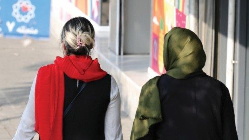 epa11605786 An Iranian woman (L) without a mandatory headscarf, or hijab, walks in a street in ... epa11605786 An Iranian woman (L) without a mandatory headscarf, or hijab, walks in a street in ...