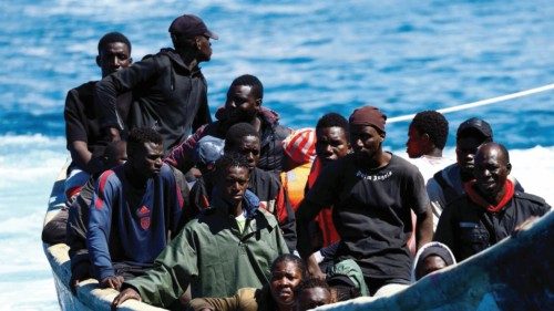 Migrants wait to disembark from a fiber boat in the port of Arguineguin, on the island of Gran ... Migrants wait to disembark from a fiber boat in the port of Arguineguin, on the island of Gran ...