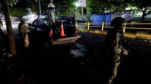 Soldiers keep watch outside a hospital where migrants injured were transferred after Mexican ... Soldiers keep watch outside a hospital where migrants injured were transferred after Mexican ...