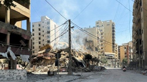 A man rides a motorbike past the damage in the aftermath of Israeli strikes on Beirut's southern ... A man rides a motorbike past the damage in the aftermath of Israeli strikes on Beirut's southern ...