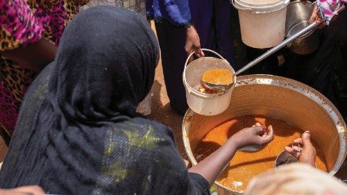 Sudanese women from community kitchens run by local volunteers distribute meals for people who are ... Sudanese women from community kitchens run by local volunteers distribute meals for people who are ...