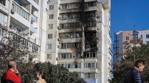 Locals stand at the site of a Russian drone strike, amid Russia's attack on Ukraine, in the city of ... Locals stand at the site of a Russian drone strike, amid Russia's attack on Ukraine, in the city of ...