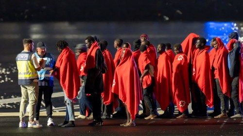 epa11648610 Migrants are assisted by a Spanish police officer and a Frontex member upon their ... epa11648610 Migrants are assisted by a Spanish police officer and a Frontex member upon their ...