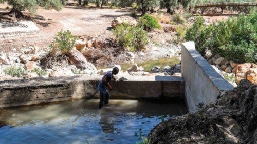 Tunisian farmer Abdallah Gadgadhi, 54, inspects the reservoir of a small irrigation dam built by ... Tunisian farmer Abdallah Gadgadhi, 54, inspects the reservoir of a small irrigation dam built by ...