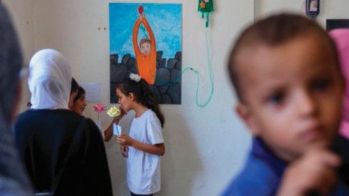 People visit an art exhibition of works by displaced Palestinian children as part of a psychological ...