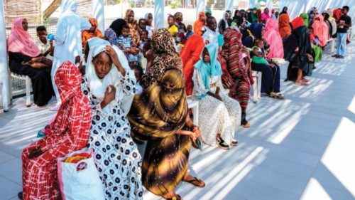 Women with children wait in the shade to receive medical care outside outside the Italian Paediatric ... Women with children wait in the shade to receive medical care outside outside the Italian Paediatric ...