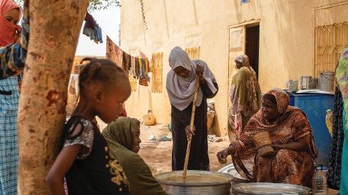 Sudanese women from community kitchens, run by local volunteers, prepare meals for people who are ... Sudanese women from community kitchens, run by local volunteers, prepare meals for people who are ...